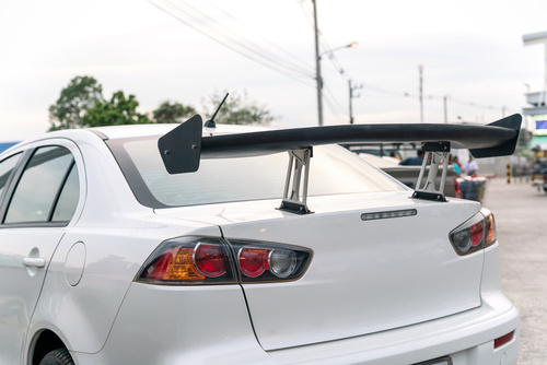 car part ; Close up detail of a custom racing carbon fiber spoil